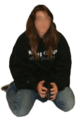 A photo of me kneeling on the floor. I am wearing black sweatshirt and jeans. Converse are on my feet. My hair is long.